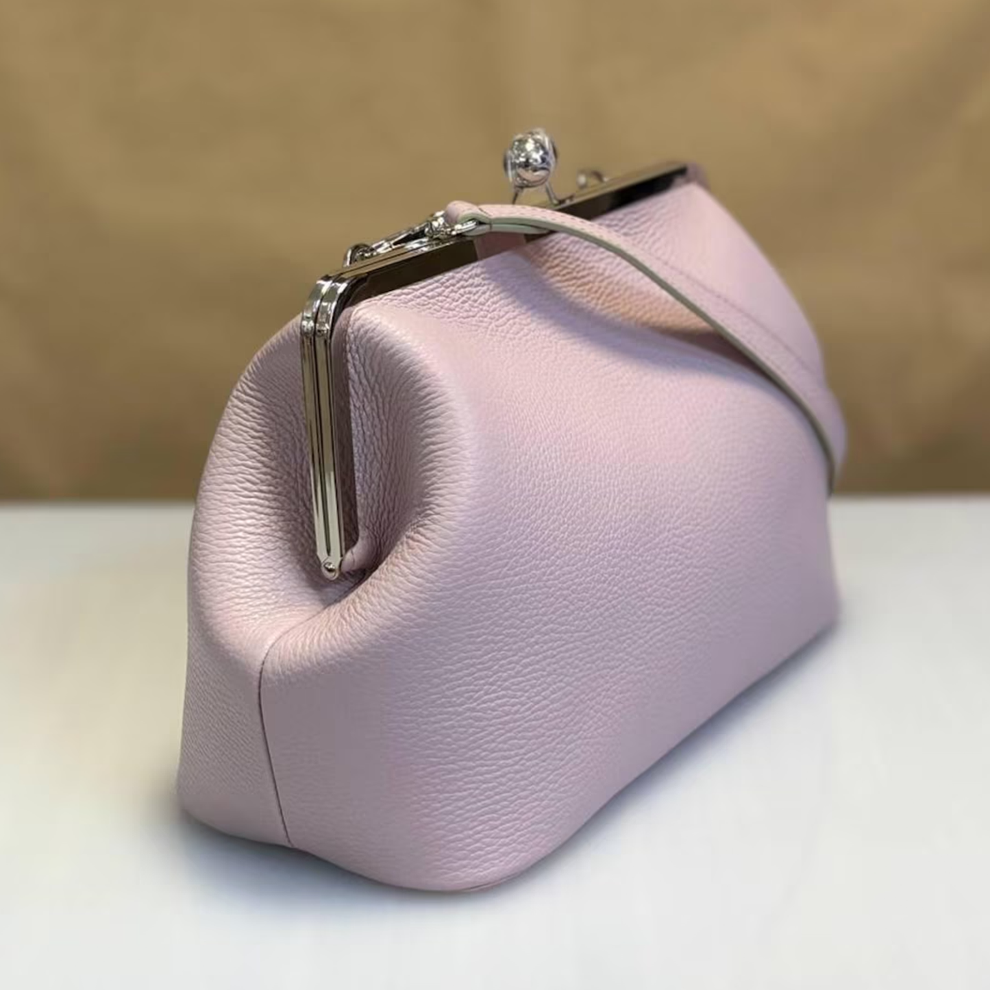 Blush Pastel Pebbled Kiss-Lock Frame Pouch With Silver Dual Ball Hardware, Slim Circular Shoulder Loop And Puffed Side Panel Silhouette