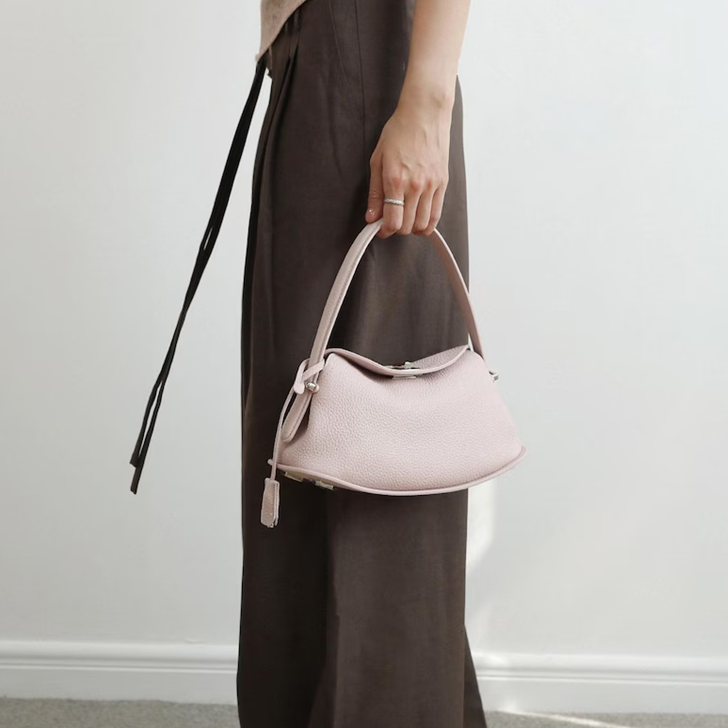 Triple-Tone Pebbled Curved Saddle Handbag With Arched Single Carry Loop, Metallic Turn-Lock Flap And Side Fabric Tab Detail