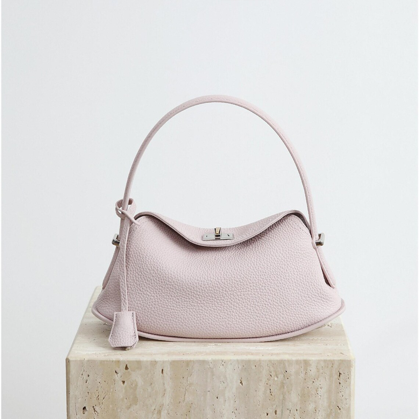 Triple-Tone Pebbled Curved Saddle Handbag With Arched Single Carry Loop, Metallic Turn-Lock Flap And Side Fabric Tab Detail