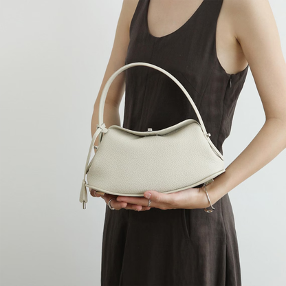 Triple-Tone Pebbled Curved Saddle Handbag With Arched Single Carry Loop, Metallic Turn-Lock Flap And Side Fabric Tab Detail